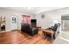 Cozy living room with hardwood floors, a comfortable leather sofa, and ample natural light at 998 Sisley Trl, White, GA 30184