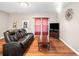 Comfortable living room with hardwood floors, a plush sofa, and a relaxed atmosphere at 998 Sisley Trl, White, GA 30184