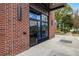 Exterior view of building entrance with brick facade and modern glass door at 112 Rogers Ne St # 503, Atlanta, GA 30317