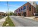 Charming brick building with large windows, the stylish 'Pullman Flats' has a welcoming entrance on a sunny day at 112 Rogers Ne St # 503, Atlanta, GA 30317