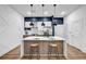 Modern kitchen featuring a large island, stainless steel appliances, pendant lighting, and stylish counter stools at 112 Rogers Ne St # 503, Atlanta, GA 30317
