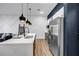 Modern kitchen with stainless steel appliances, a large island and unique lighting fixtures at 112 Rogers Ne St # 503, Atlanta, GA 30317
