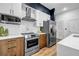 Bright kitchen features stainless steel appliances, modern cabinets, a stylish range hood, and ample counter space at 112 Rogers Ne St # 503, Atlanta, GA 30317