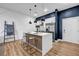 Modern kitchen with stainless steel appliances, a center island with seating, and unique wall accents at 112 Rogers Ne St # 503, Atlanta, GA 30317