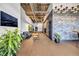 Open lobby area with exposed ceilings, brick accents, seating, and plants at 112 Rogers Ne St # 503, Atlanta, GA 30317