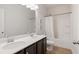 Bright bathroom featuring double sinks with a dark vanity and a shower-tub combination at 1151 Wisteria Sw Dr, Mableton, GA 30126