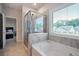 Bright bathroom featuring a soaking tub and glass enclosed shower offering a spa-like experience at 1151 Wisteria Sw Dr, Mableton, GA 30126