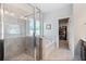 Luxurious bathroom featuring a glass-enclosed shower, soaking tub, and access to the walk-in closet at 1151 Wisteria Sw Dr, Mableton, GA 30126