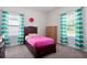 Comfortable bedroom showcasing bright, colorful curtains and a matching pink bedspread at 1151 Wisteria Sw Dr, Mableton, GA 30126