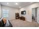 Comfortable bonus room featuring a futon, television, and shelving for storage and entertainment at 1151 Wisteria Sw Dr, Mableton, GA 30126