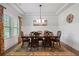 Elegant dining room featuring a wooden table with seating for six and a decorative chandelier at 1151 Wisteria Sw Dr, Mableton, GA 30126