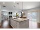 Open-concept kitchen with a central island flowing into the living area with fireplace at 1151 Wisteria Sw Dr, Mableton, GA 30126