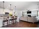 Open-concept kitchen and living area with barstool seating, fireplace, and hardwood floors at 1151 Wisteria Sw Dr, Mableton, GA 30126