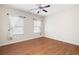 Bright bedroom featuring hardwood floors, ceiling fan, and windows at 2417 Tree Arbor Way, Marietta, GA 30064