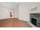Open-concept living area with hardwood floors, a stone fireplace, and abundant natural light at 2417 Tree Arbor Way, Marietta, GA 30064
