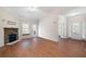 Bright living room featuring a stone fireplace, hardwood floors, neutral walls, and a ceiling fan at 2417 Tree Arbor Way, Marietta, GA 30064