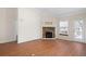 Bright living room featuring a stone fireplace, hardwood floors, neutral walls, and a ceiling fan at 2417 Tree Arbor Way, Marietta, GA 30064