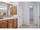 Bathroom with tile flooring, wooden vanity and large mirror, plus linen closet at 5210 Davenport Pl, Roswell, GA 30075