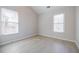 A light and airy bedroom with high ceilings and two windows offering plenty of natural light at 5210 Davenport Pl, Roswell, GA 30075