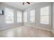 Bright bedroom featuring large windows, vaulted ceilings, and light hardwood floors at 5210 Davenport Pl, Roswell, GA 30075