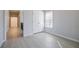 Bedroom with light wood-look floors, natural light and double door closet at 5210 Davenport Pl, Roswell, GA 30075