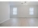 Open bedroom with neutral walls and flooring and modern lighting fixture at 5210 Davenport Pl, Roswell, GA 30075