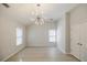 Bright bedroom features modern light fixture, two windows and beautiful hardwood floors at 5210 Davenport Pl, Roswell, GA 30075