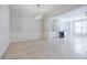 Bright dining room with white wainscoting, decorative chandelier and light hardwood floors at 5210 Davenport Pl, Roswell, GA 30075