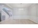 Bright dining area with wainscoting detail and modern chandelier, open to living area and stairs at 5210 Davenport Pl, Roswell, GA 30075