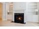 Close-up of the living room fireplace with black marble hearth and white custom built-ins at 5210 Davenport Pl, Roswell, GA 30075