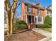 Charming red brick townhouse with landscaped front yard and traditional architectural details at 5210 Davenport Pl, Roswell, GA 30075