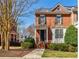 Charming two-story red brick townhouse with manicured landscaping and inviting front porch at 5210 Davenport Pl, Roswell, GA 30075
