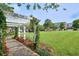 White pergola and manicured lawn create a serene and inviting outdoor space at 5210 Davenport Pl, Roswell, GA 30075