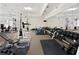Bright gym with mirrored wall, carpeted flooring, and a variety of exercise equipment at 5210 Davenport Pl, Roswell, GA 30075