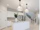 Kitchen featuring an island with pendant lighting, stainless appliances, and white cabinets at 5210 Davenport Pl, Roswell, GA 30075