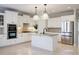 Open-concept kitchen with white cabinets, granite countertops, stainless steel appliances, and pendant lighting at 5210 Davenport Pl, Roswell, GA 30075