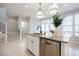 Updated kitchen features white cabinets, granite countertops, stainless appliances, and a kitchen island at 5210 Davenport Pl, Roswell, GA 30075