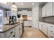 Modern kitchen featuring white cabinetry, granite countertops, stainless appliances, and an island with a sink at 5210 Davenport Pl, Roswell, GA 30075