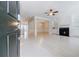 Bright open-concept living room with fireplace, built-in shelves, and fresh white paint at 5210 Davenport Pl, Roswell, GA 30075