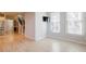 Open-concept living room with hardwood floors, adjacent to the staircase and stainless steel appliances at 5210 Davenport Pl, Roswell, GA 30075