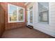 Outdoor patio with a brick wall, white siding, and a wooden deck at 5210 Davenport Pl, Roswell, GA 30075