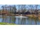 Beautiful lake view featuring a fountain and lakeside condos with balconies overlooking the water at 5210 Davenport Pl, Roswell, GA 30075