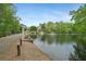 Scenic pond view featuring a fountain and walking path in a well-maintained community at 5210 Davenport Pl, Roswell, GA 30075