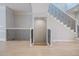 Staircase with black iron railings and light wood-look flooring leading to the lower level at 5210 Davenport Pl, Roswell, GA 30075