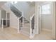 Staircase with black iron railing and carpeted steps, leading to the upper floors at 5210 Davenport Pl, Roswell, GA 30075