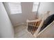 Carpeted stairs with black and white railings let in a lot of natural light at 5210 Davenport Pl, Roswell, GA 30075