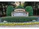 Stone community sign with flowers, landscaping, and neighborhood welcome at 58 Basswood Cir # 29, Atlanta, GA 30328