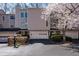 Inviting townhome exterior with attached garage and lovely flowering tree in the front yard at 58 Basswood Cir # 29, Atlanta, GA 30328