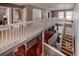 Spacious upper hallway boasts bridge and staircase with hardwood floors and natural light at 58 Basswood Cir # 29, Atlanta, GA 30328