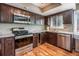 Kitchen with stainless steel appliances, granite countertops, and dark wood cabinets at 58 Basswood Cir # 29, Atlanta, GA 30328